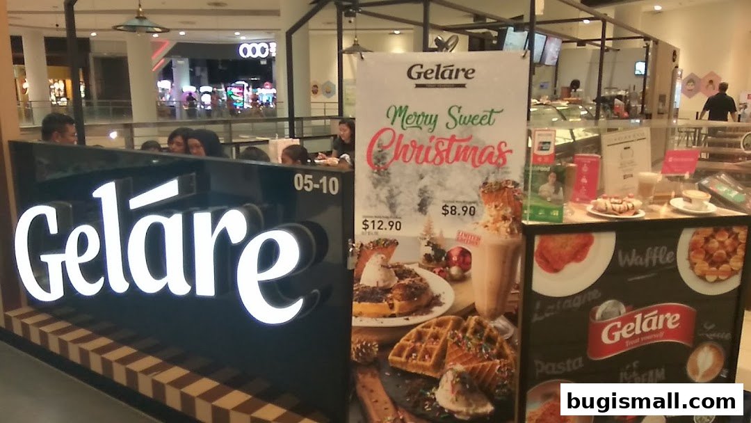 Geláre shop front with a Christmas promotion and display of waffles and drinks.