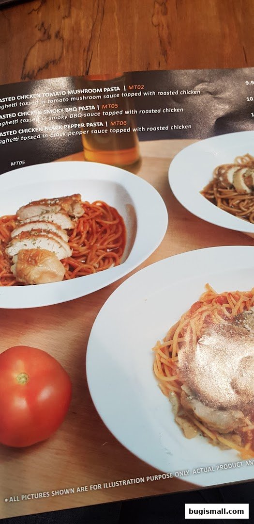 A menu featuring pasta dishes with roasted chicken and a fresh tomato.