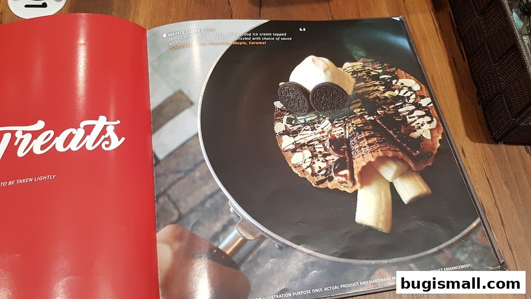 A menu page showcasing a waffle cone dessert with ice cream, bananas, and chocolate sauce.