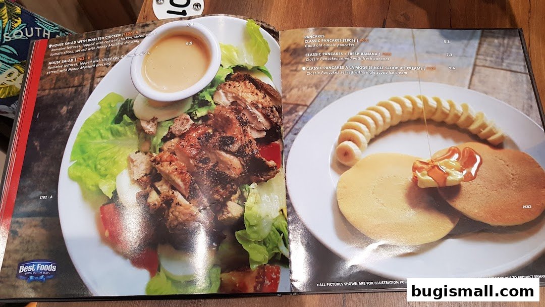 A menu featuring salads and pancakes with appealing food photography.