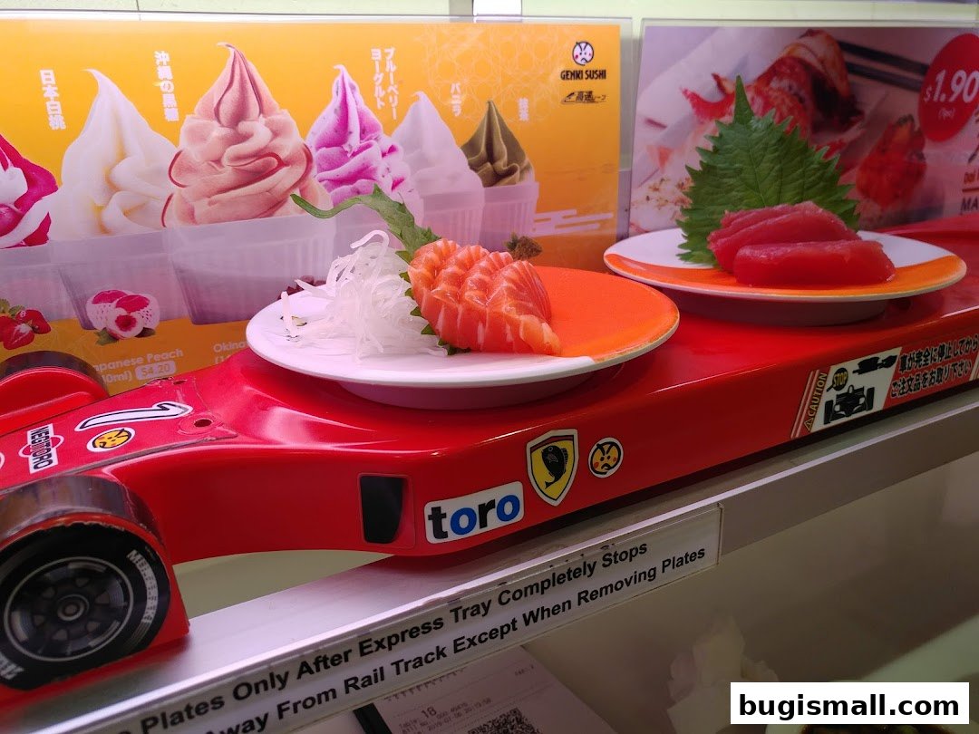 Sushi plates on a red conveyor belt with a background advertising soft serve ice cream.