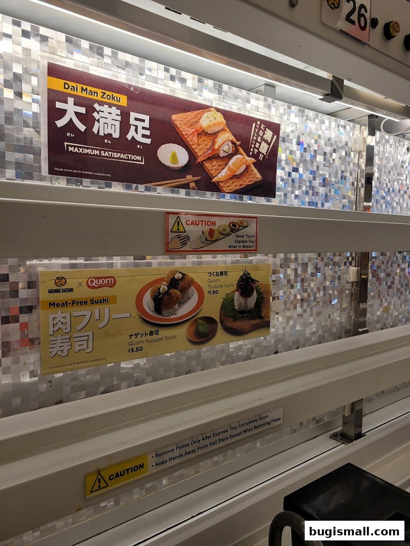 Genki Sushi advertises its 'Dai Man Zoku' and meat-free sushi options.