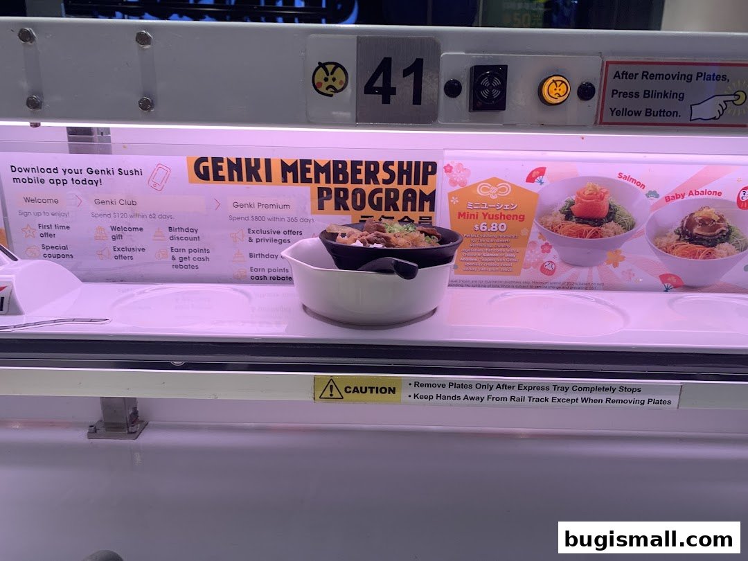 Genki Sushi conveyor belt with membership program details and menu items.