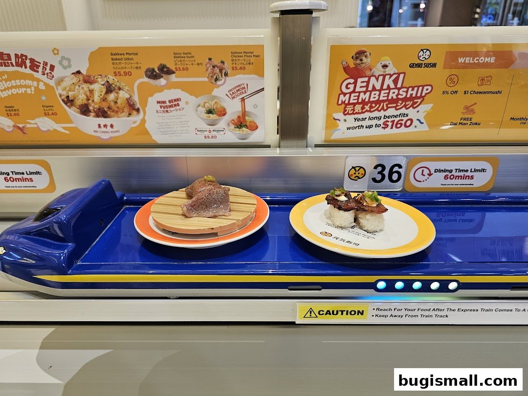 Sushi served on a conveyor belt train with menu items and membership offers displayed.