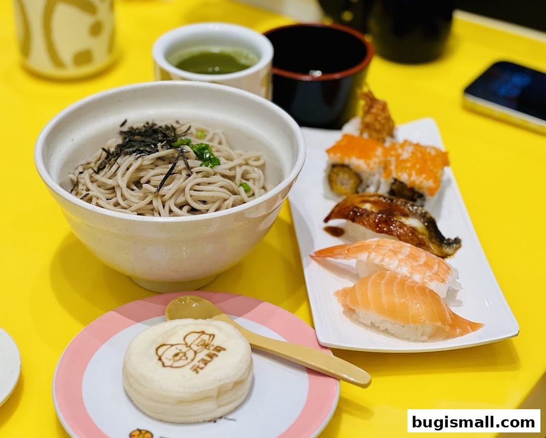 A table setting with soba noodles, sushi, and a dessert at Genki Sushi.