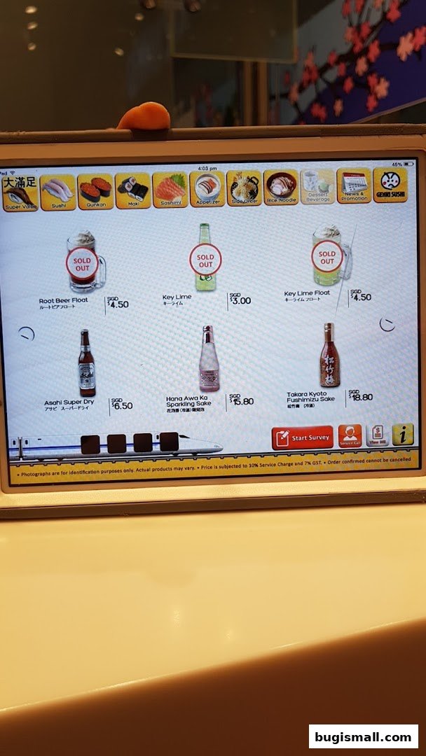 A tablet displaying a menu of sushi and drinks at Genki Sushi.