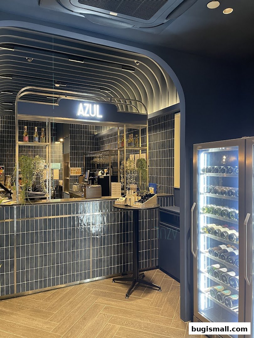 Interior view of a modern bar area with a wine fridge and counter.