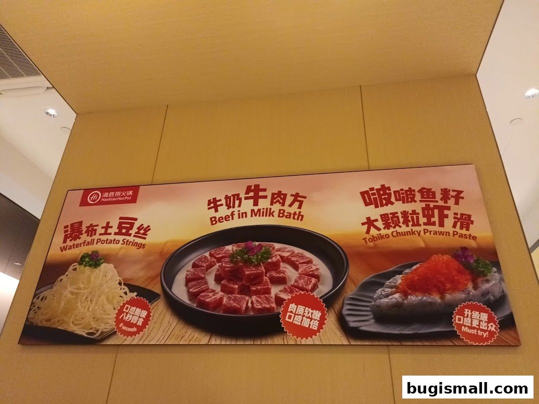 A promotional banner for Haidilao Hot Pot featuring three signature dishes: Waterfall Potato Strings, Beef in Milk Bath, and Tobiko Chunky Prawn Paste.