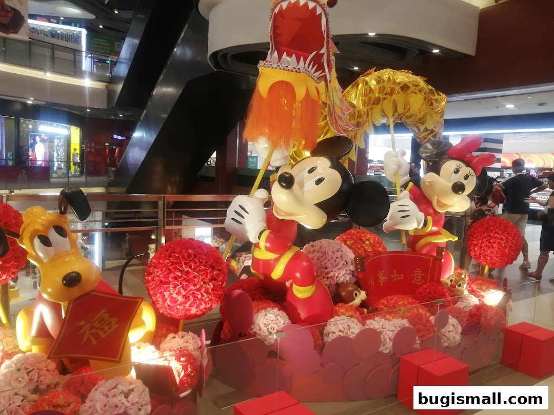 Mickey Mouse, Minnie Mouse, and Pluto decorations with a dragon and floral arrangements.