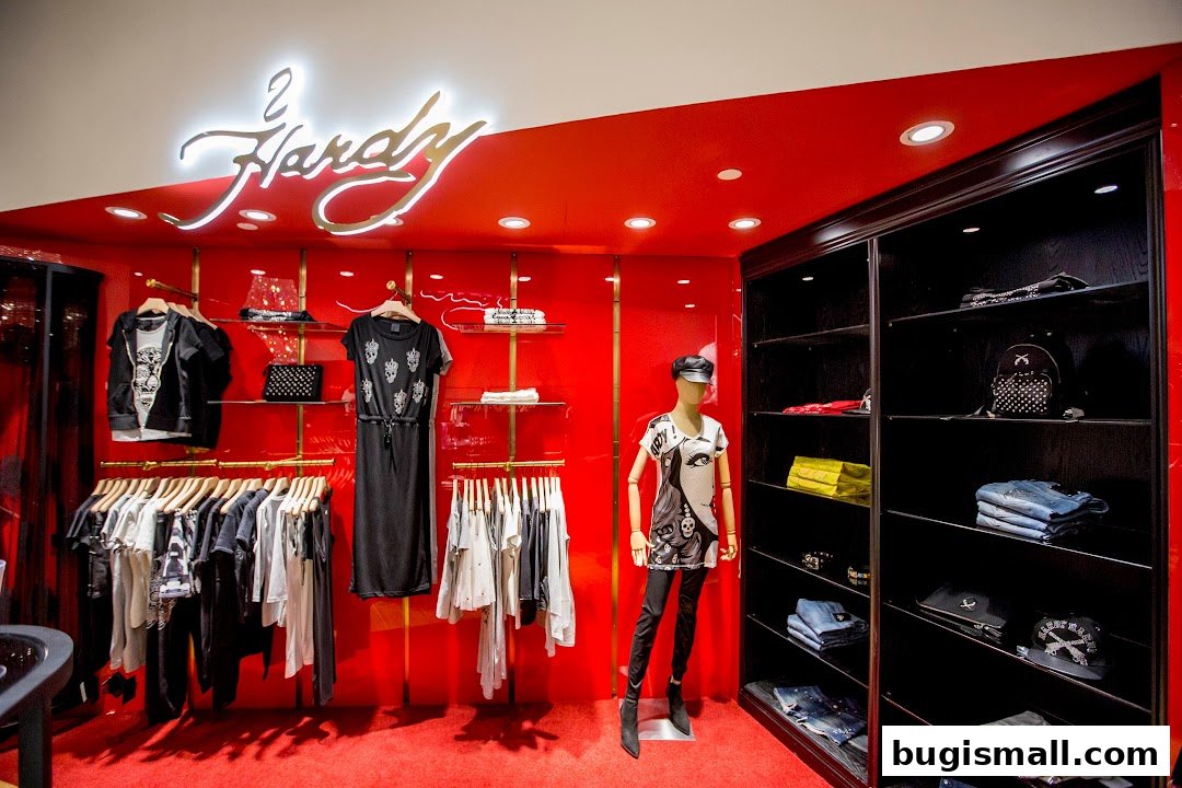 Interior of a clothing store with racks of apparel, a mannequin, and shelves displaying accessories.
