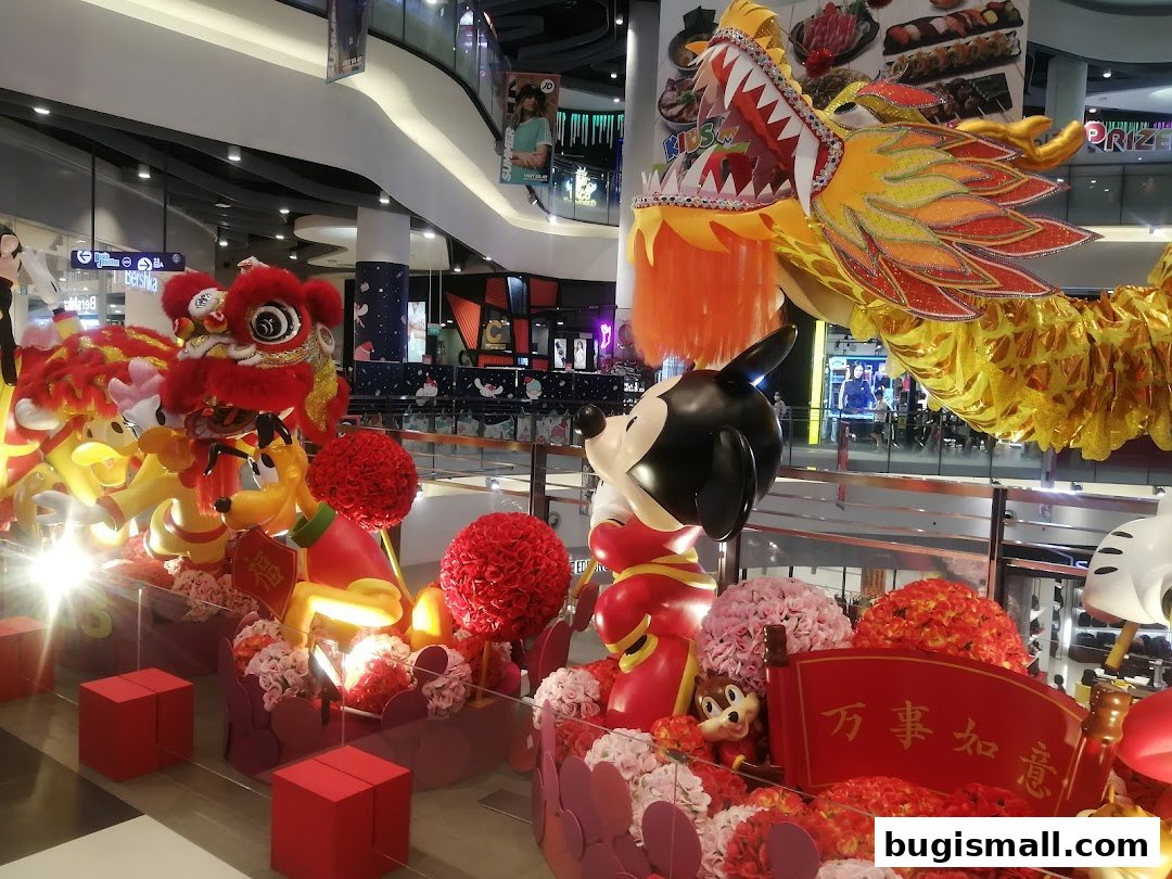 A festive Chinese New Year display featuring lion dance figures, a dragon, and Disney characters in a mall.