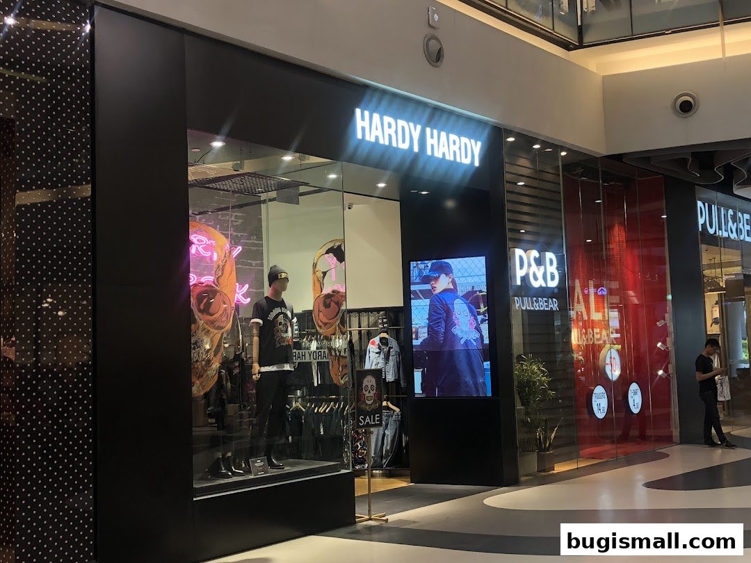 The Hardy Hardy store front with mannequins and a digital display.