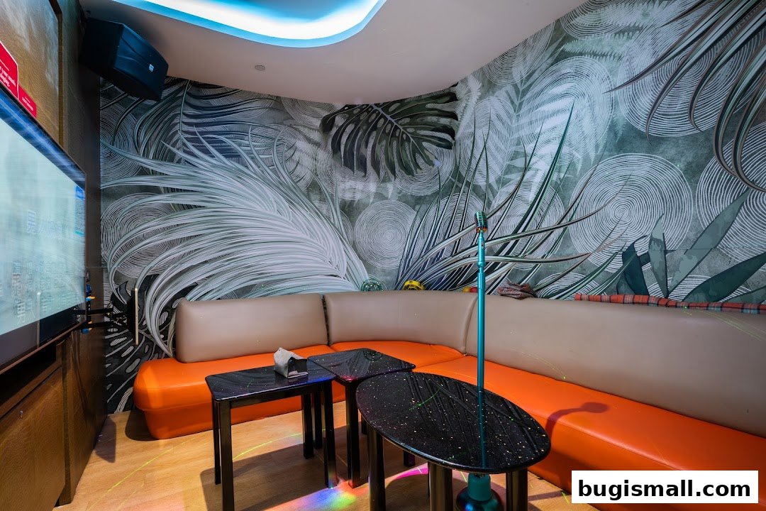 A stylish karaoke room with tropical wallpaper, orange seating, and a vintage microphone.
