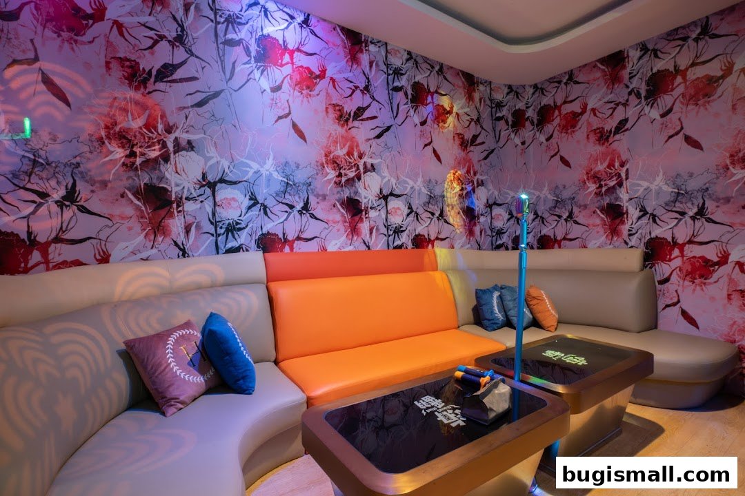 A stylish karaoke room with floral wallpaper, comfortable seating, and microphones on tables.
