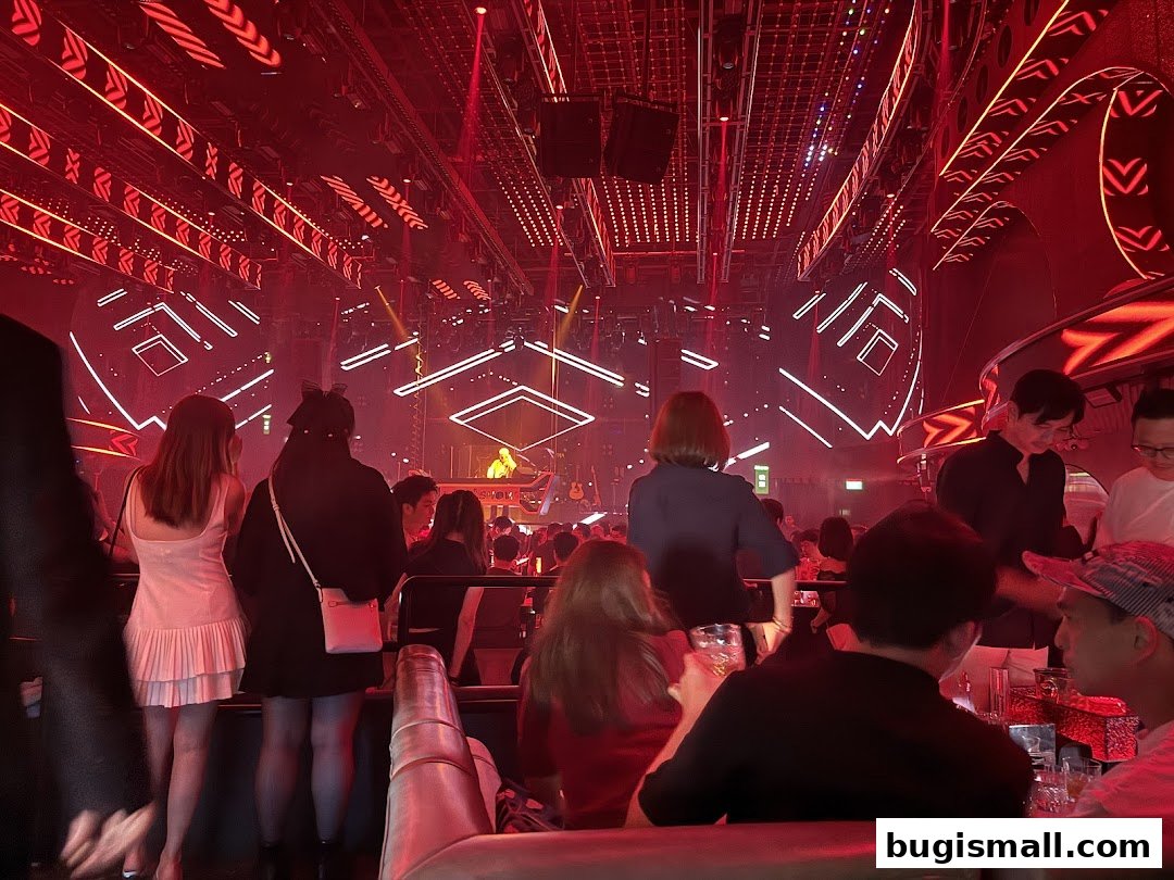 People enjoying a lively atmosphere with a DJ and stage at HaveFun Karaoke Bugis Plus.