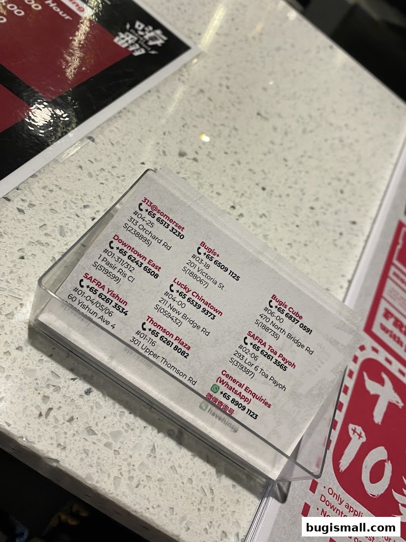 A clear plastic holder displays contact information for multiple HaveFun Karaoke locations.