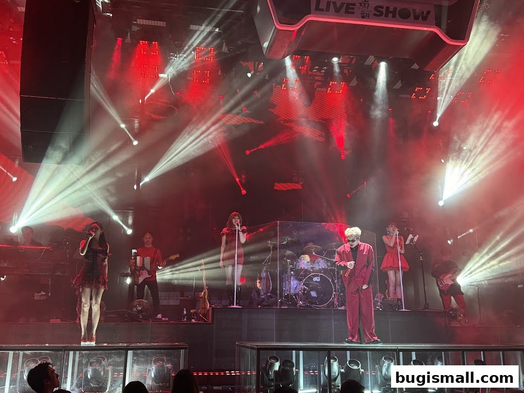 A live band performs on stage with dramatic red and white lighting and a 'LIVE SHOW' sign.