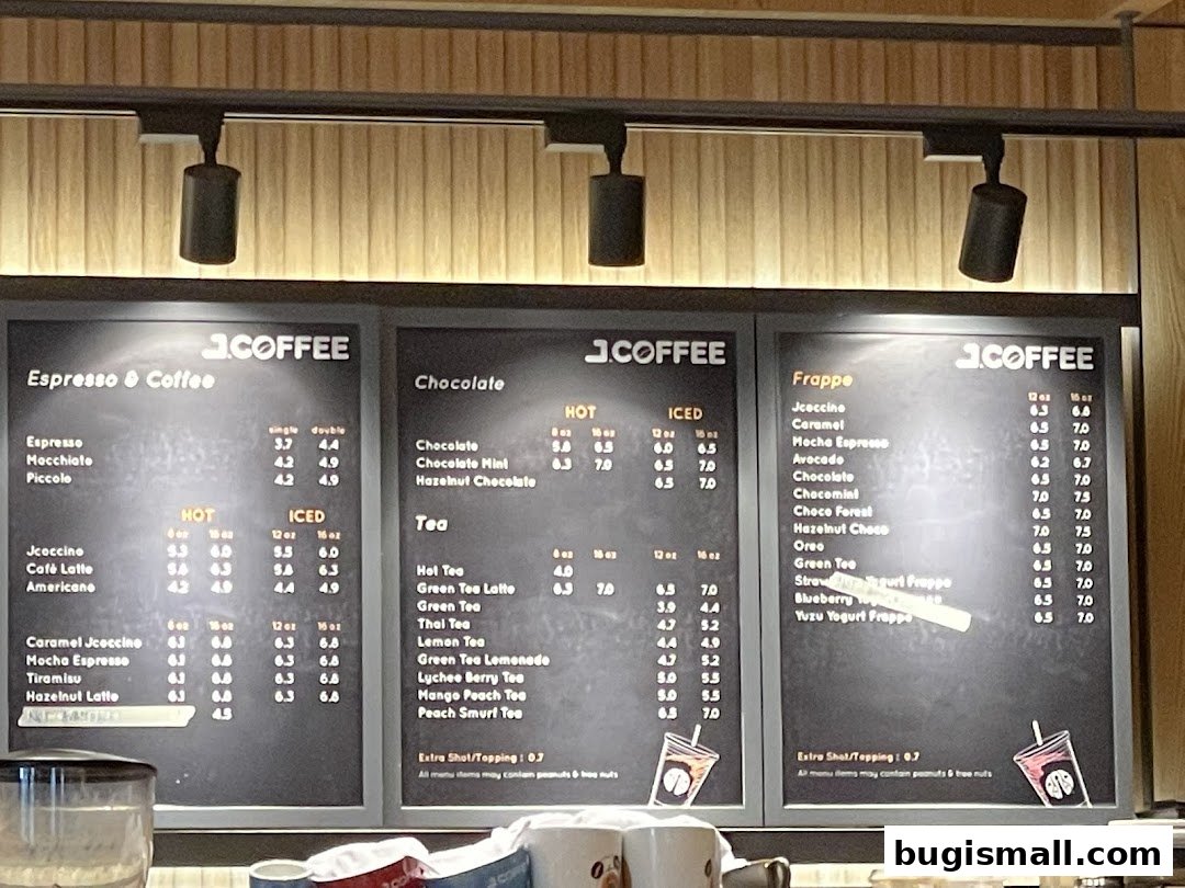 A menu board displaying various coffee and tea drinks with prices.