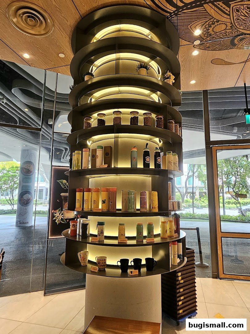 A multi-tiered display shelf showcasing various drinkware and coffee-related items.