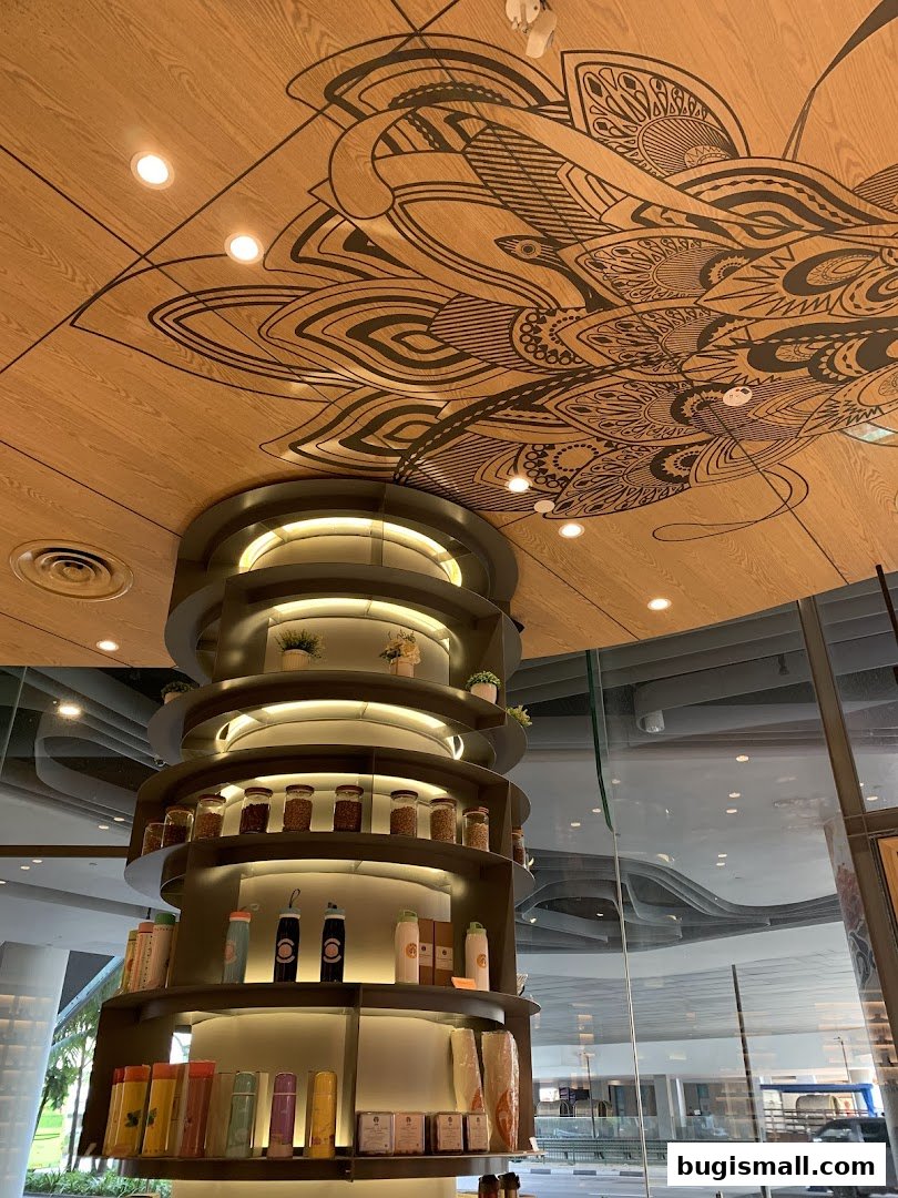 Interior view of J.CO Donuts & Coffee with a decorative ceiling and display shelves.