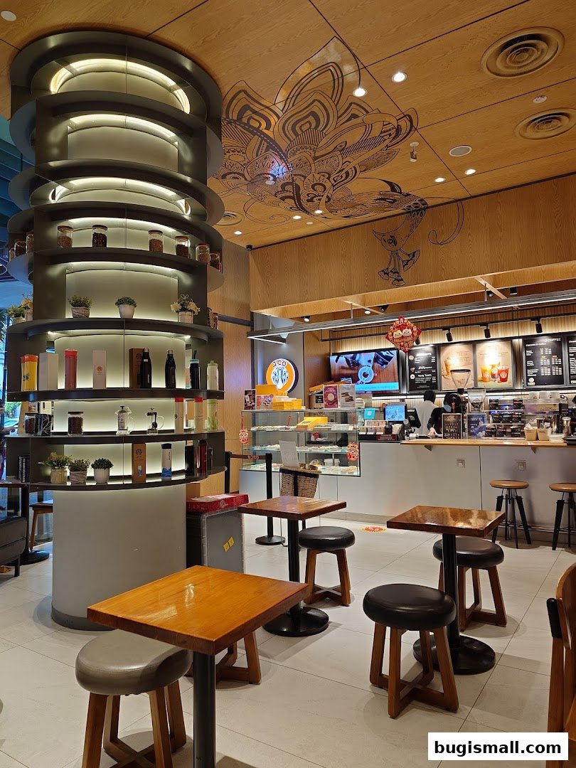 Interior view of J.CO Donuts & Coffee with seating, display shelves, and counter.