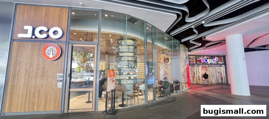 The exterior of a J.CO Donuts & Coffee shop with a modern design and large glass windows.