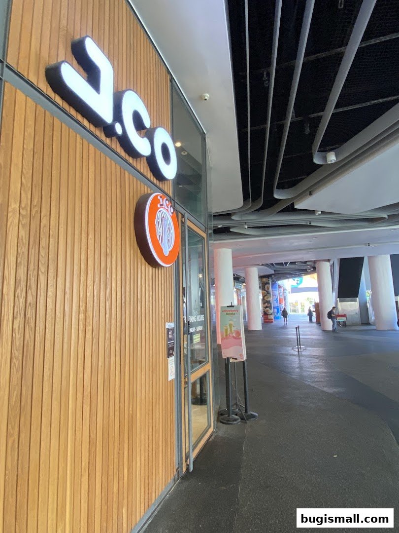 The exterior of a J.CO Donuts & Coffee shop with its prominent signage and wooden facade.