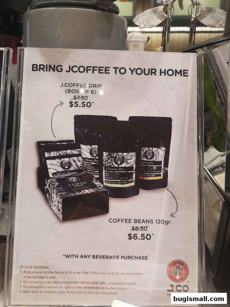 A sign advertising J.COFFEE DRIP and COFFEE BEANS with prices and terms.