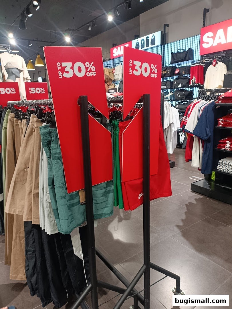 JD Sports store interior with sale signs and racks of clothing.