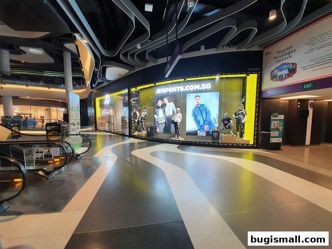The JD Sports store front with a large display window showcasing models and the store's website.