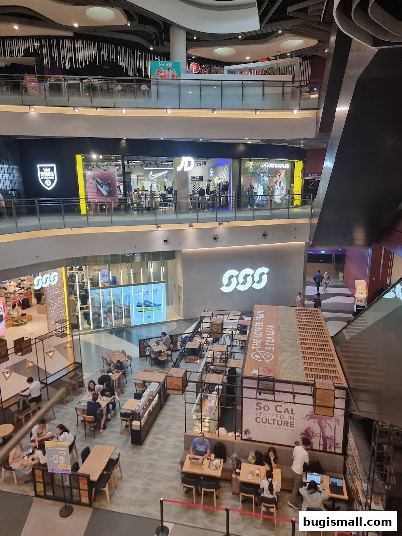 A view of a shopping mall interior showing JD Sports and a coffee shop.
