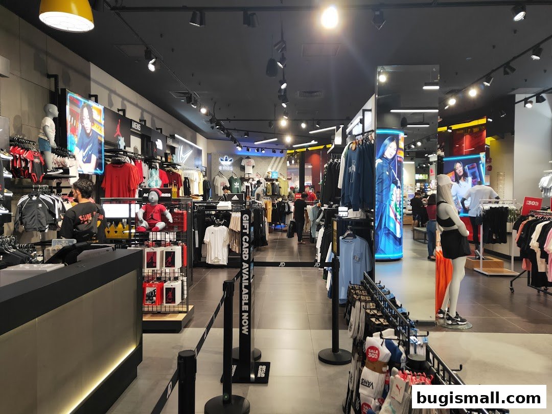 Interior view of a JD Sports store showcasing apparel, footwear, and accessories.