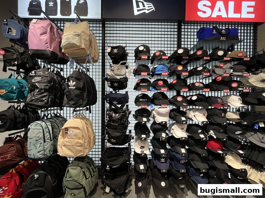 A wall display of various backpacks and caps, with a prominent 'SALE' sign.