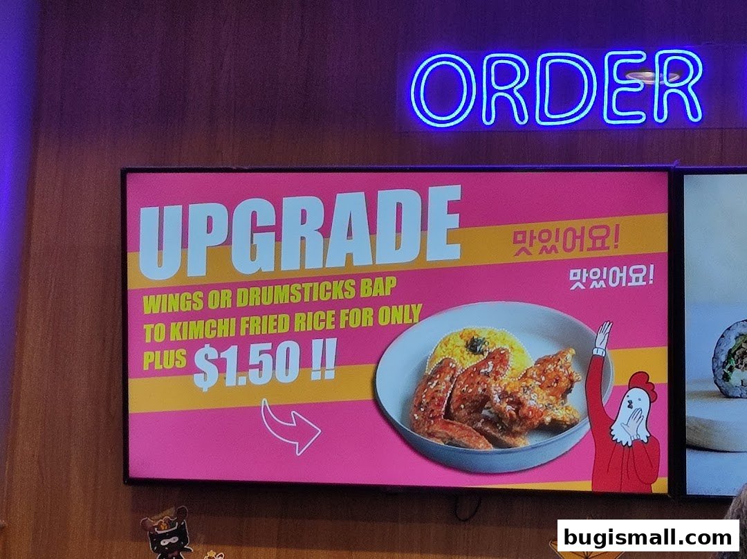 A digital menu board advertising an upgrade to kimchi fried rice for $1.50.
