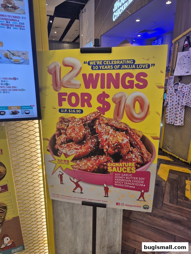 A promotional sign for JINJJA Chicken celebrating 10 years with a 12 wings for $10 deal.