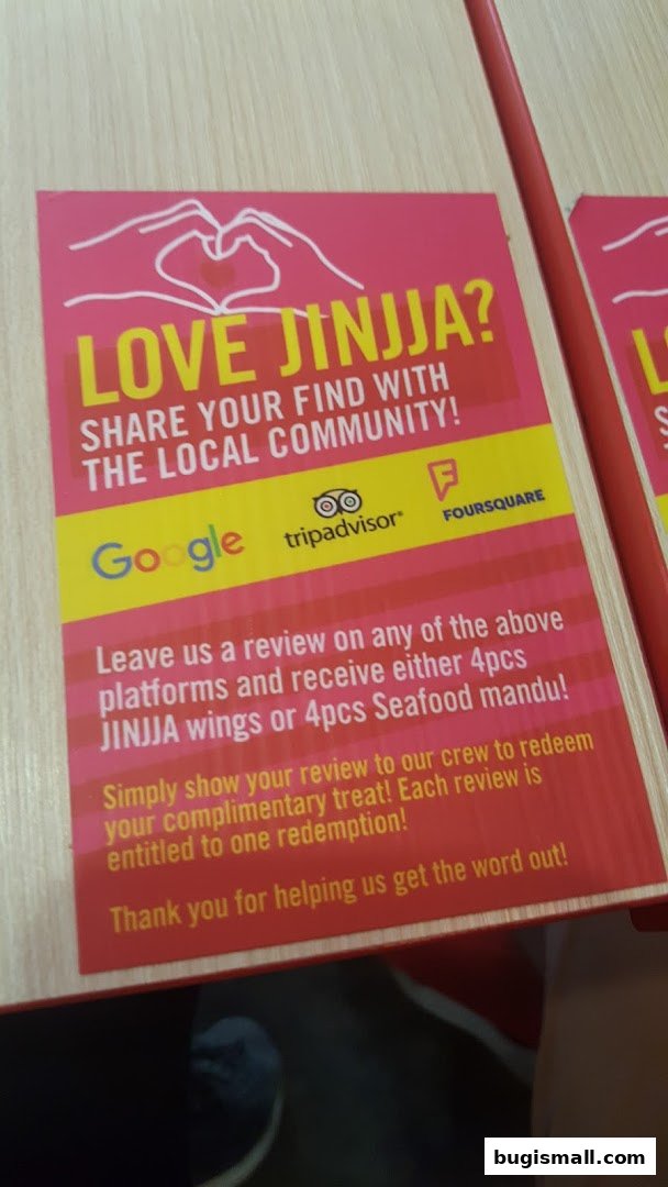 A flyer encouraging customers to leave reviews for JINJJA Chicken to receive free food.