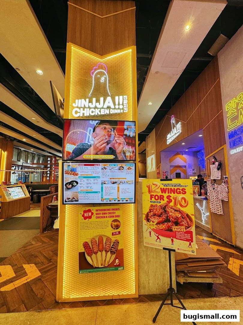 Jinjja Chicken Diner storefront with digital menus and promotional posters.