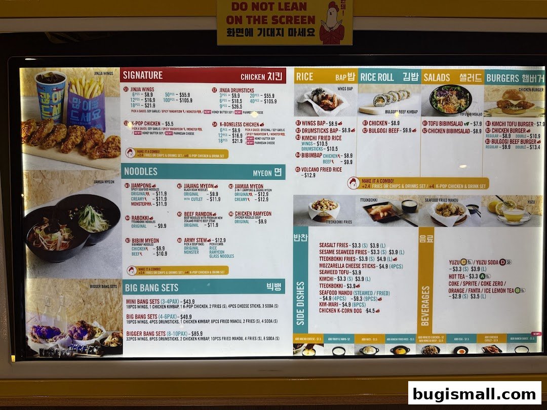 A menu board displaying various Korean fried chicken dishes, noodles, rice, and beverages.