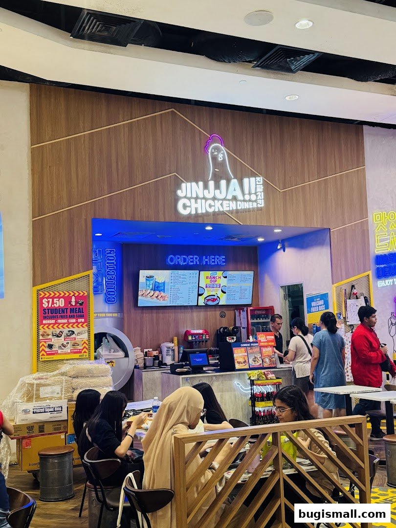 Customers dine at JINJJA Chicken Diner, with a prominent "ORDER HERE" sign and menu displayed.