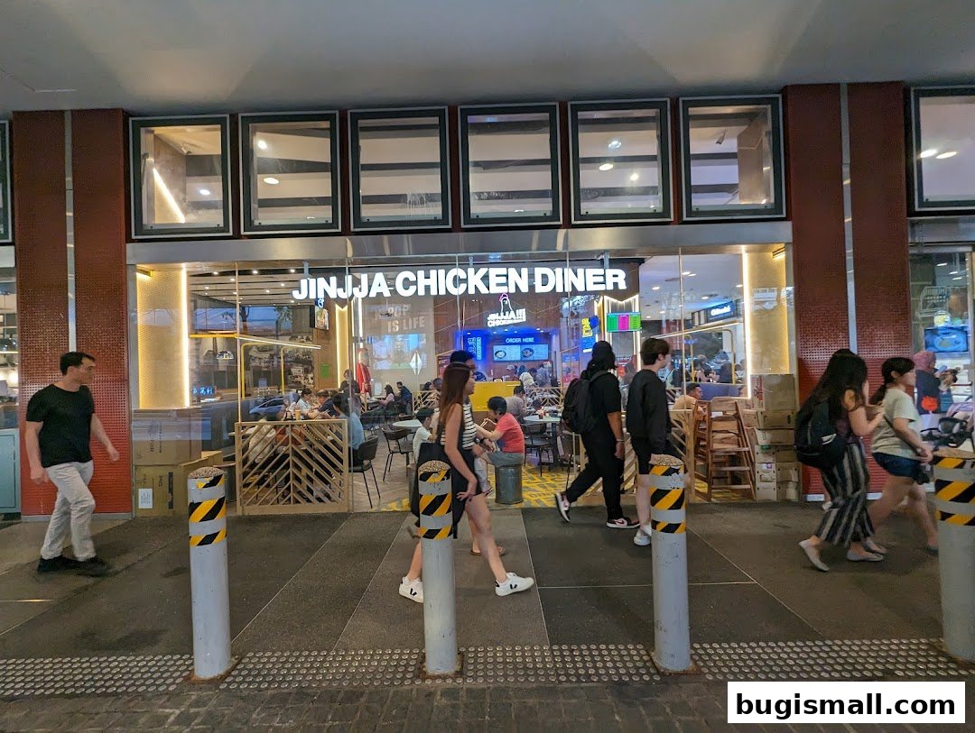 The exterior of JINJJA Chicken Diner with people walking by.
