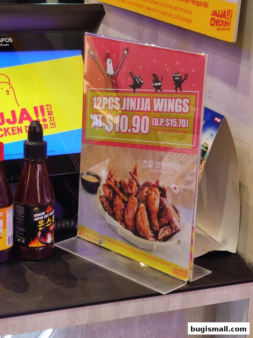 A promotional flyer for JINJJA Chicken featuring 12 pieces of wings at a discounted price.