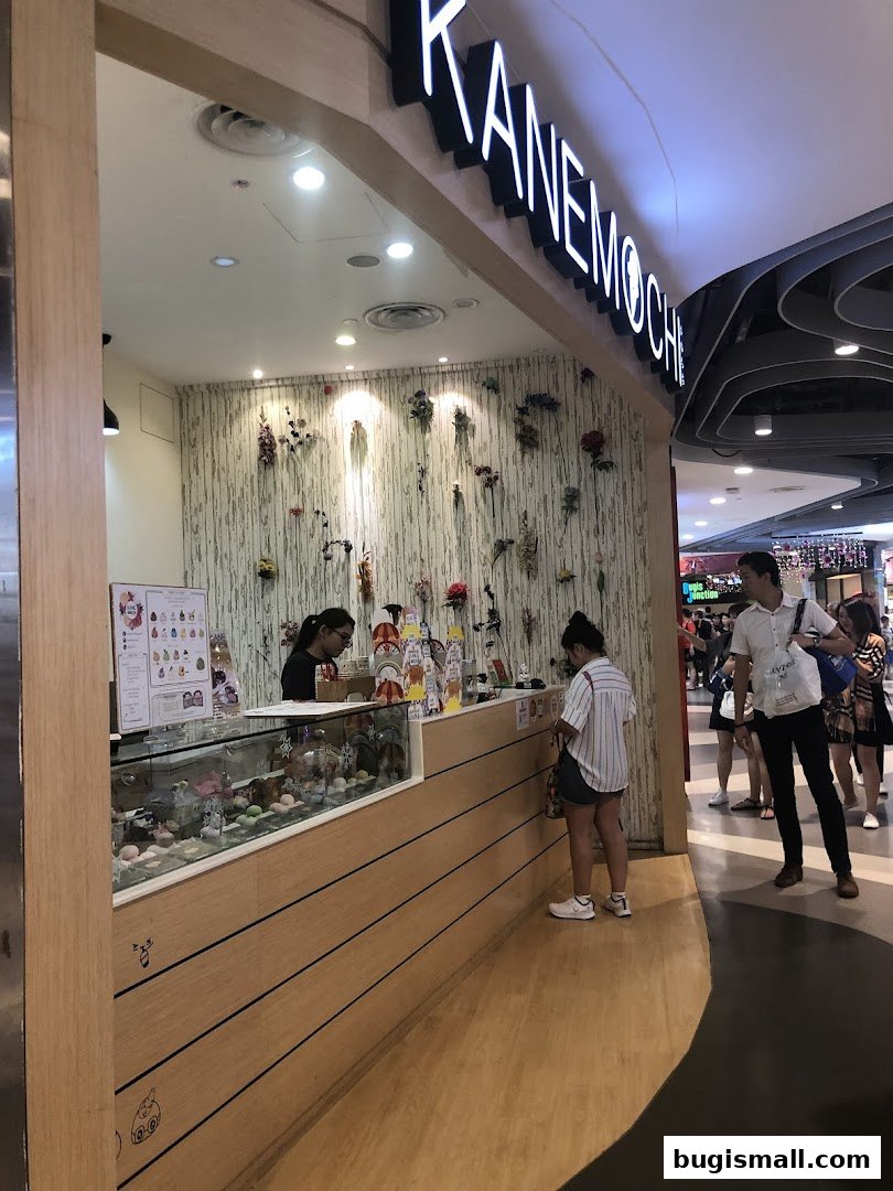 A Kane Mochi shop with a display of mochi and customers ordering.