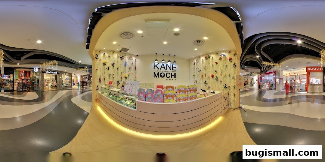 A Kane Mochi shop counter decorated with flowers, displaying mochi ice cream and branded boxes.
