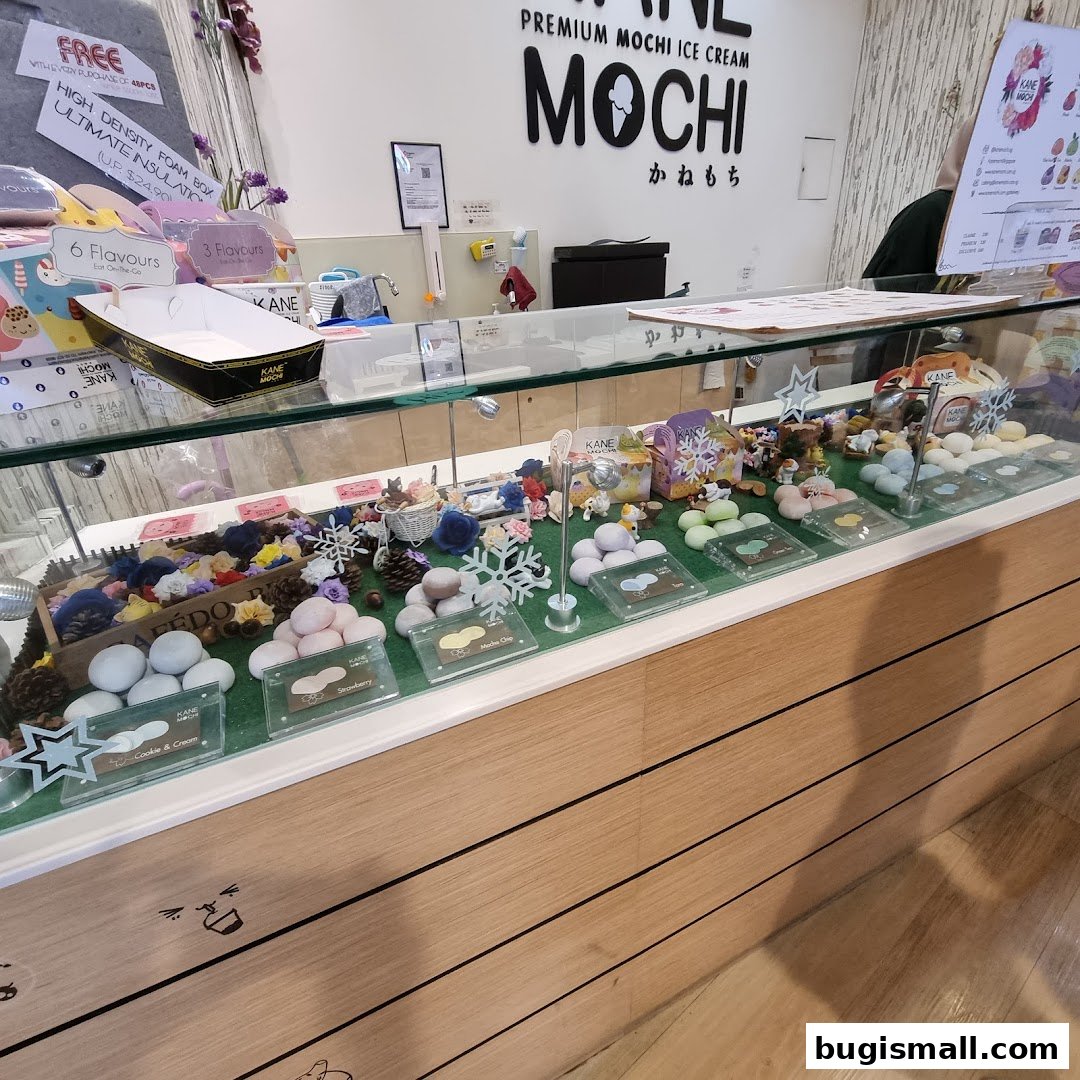 A display case filled with colorful mochi ice cream flavors and decorative elements.