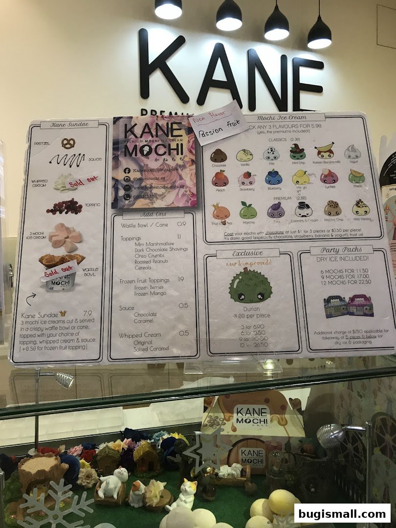 A menu board for Kane Mochi, showcasing ice cream flavors, sundaes, and toppings.