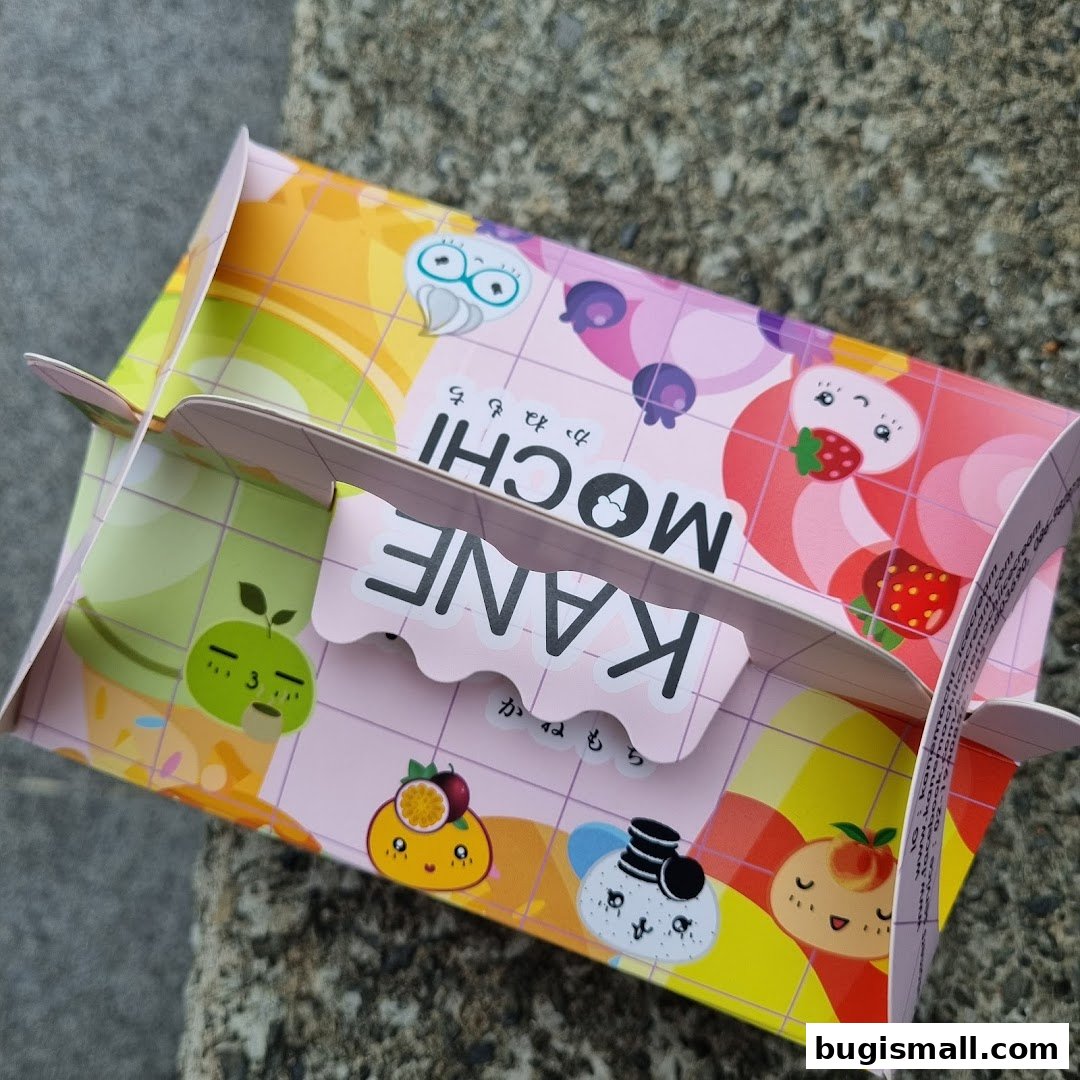A colorful box from KANE MOCHI featuring cute fruit characters and Japanese text.