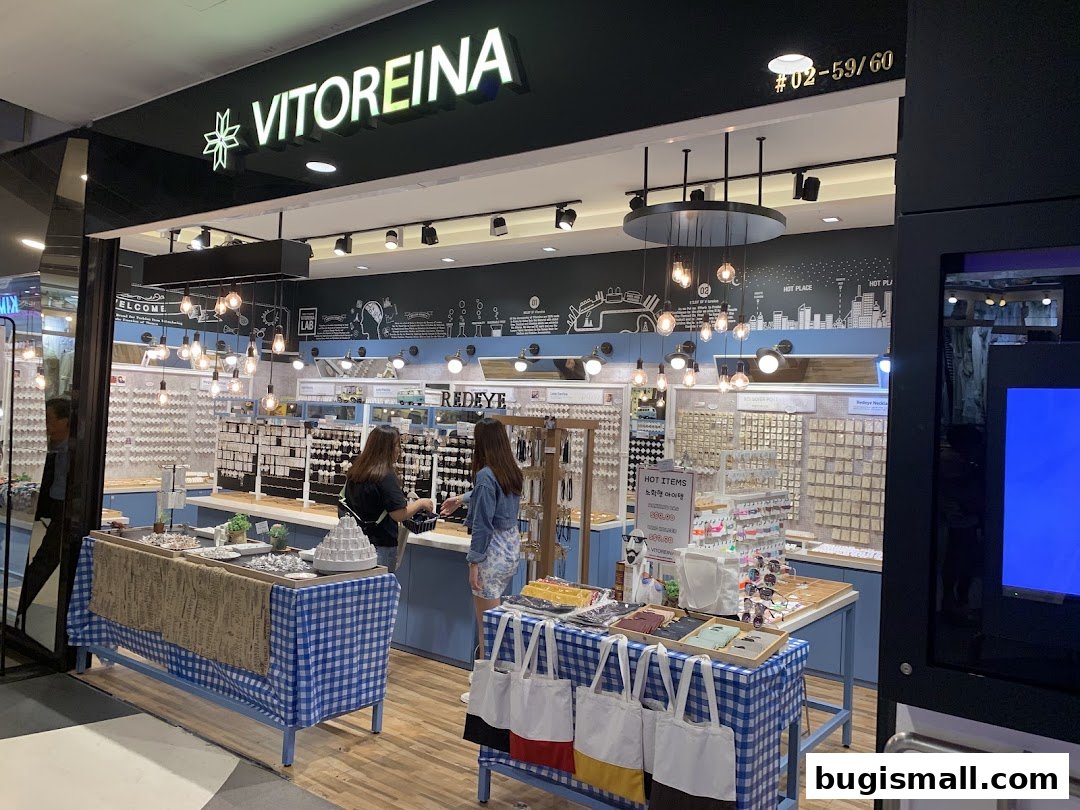 A well-lit jewelry store with displays of accessories and two customers browsing.