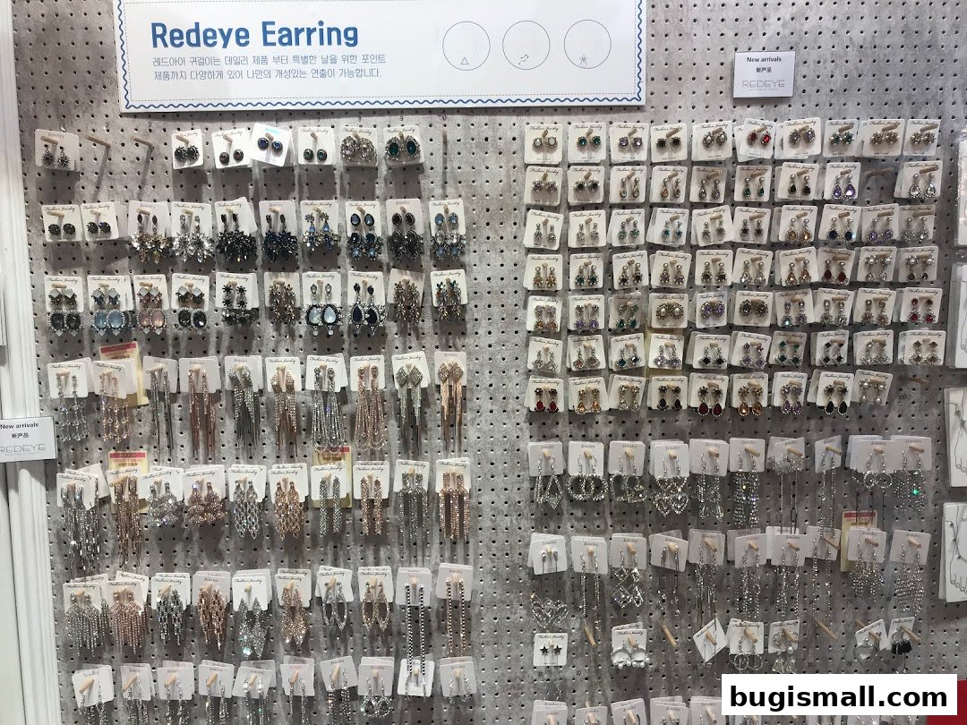 A wall display showcasing a wide variety of earrings, organized by style and color.