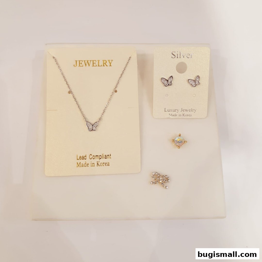 A display of delicate butterfly-themed jewelry, including a necklace and earrings.