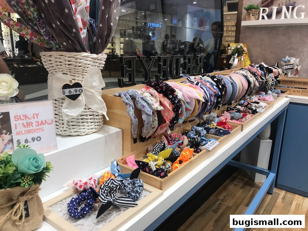 A display of colorful hairbands and scrunchies in wooden trays at a retail shop.